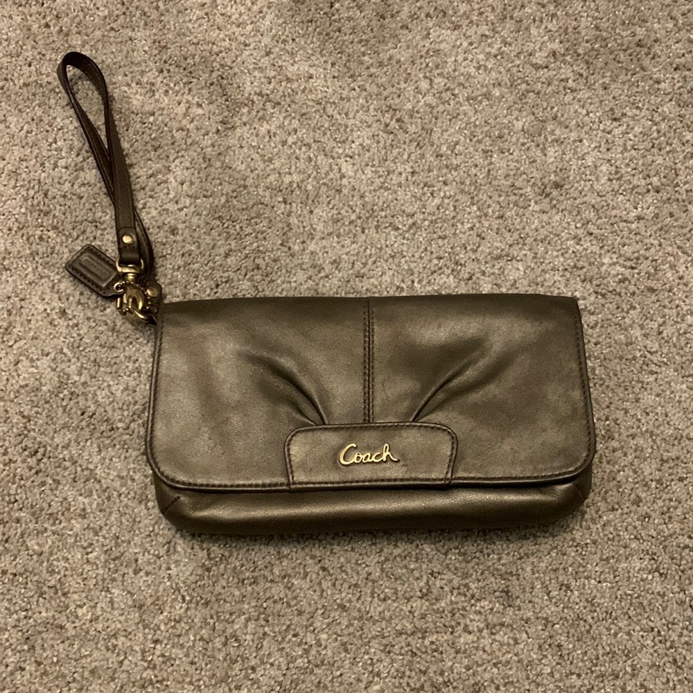 Coach wristlet, gold with card holder inside.